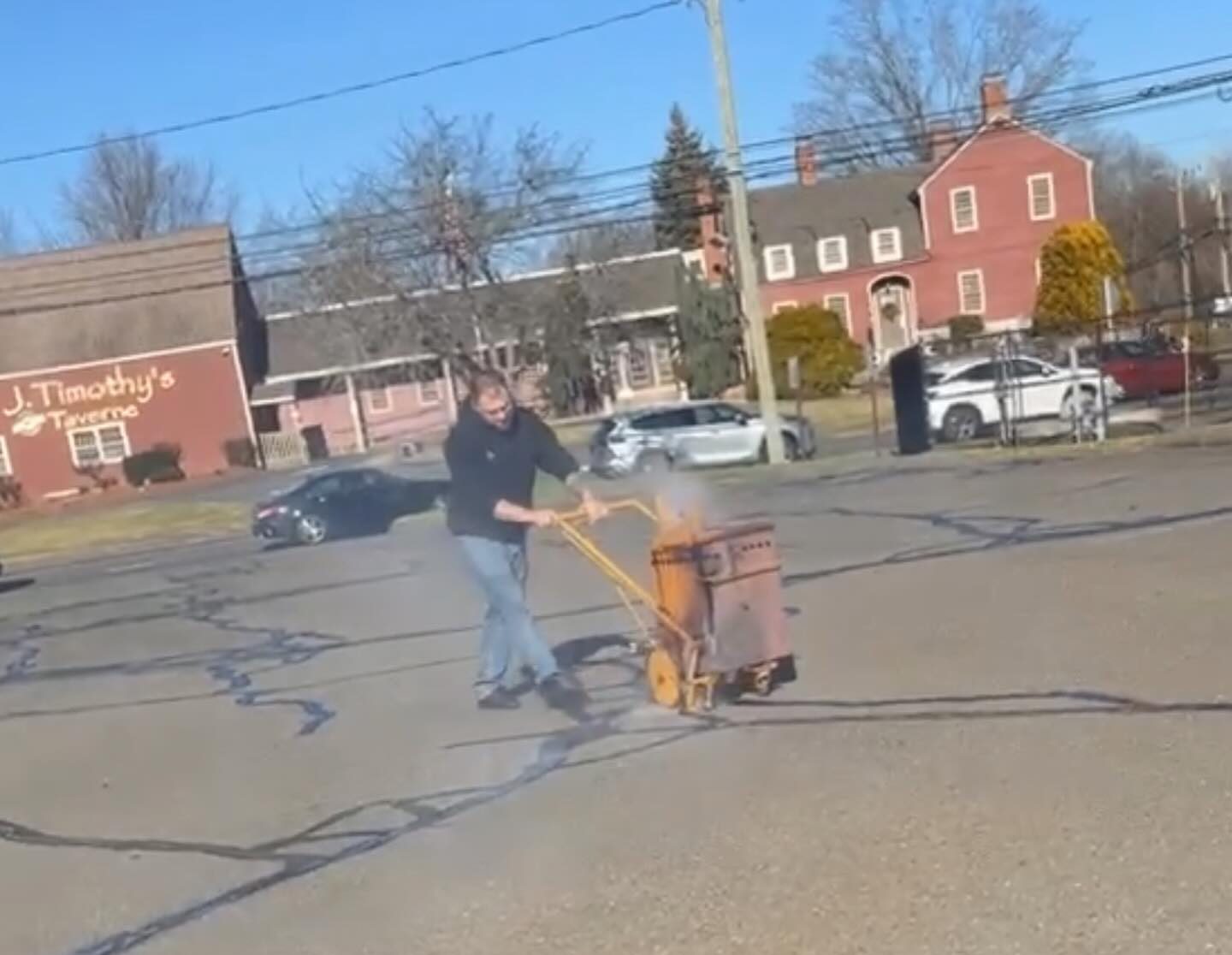 A technician from Fasano's Sealcoating is performing hot crack patch repair on an asphalt driveway in Meriden, CT. The worker uses specialized equipment to fill and seal the cracks with hot, flexible material, preventing further damage. Fasano's Sealcoating provides expert hot crack patch repair services across all of Connecticut, ensuring long-lasting protection for asphalt surfaces.