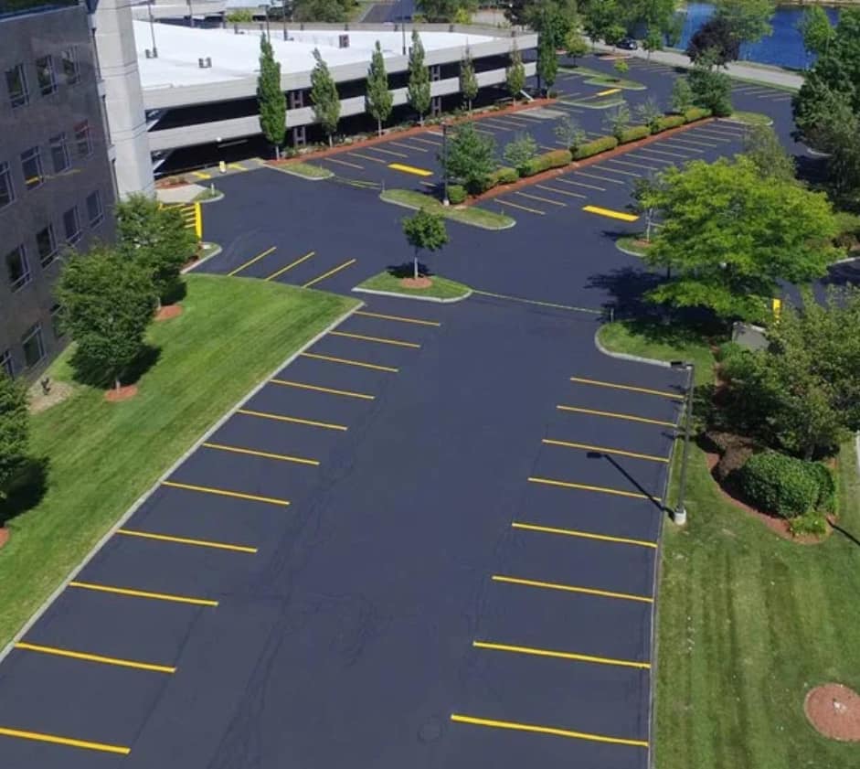 A crew from Fasano's Sealcoating is seen paving a new asphalt driveway in Meriden, CT. The team operates heavy machinery to lay down and smooth the fresh asphalt, ensuring a level and durable surface. Fasano's Sealcoating offers professional paving services throughout Connecticut, delivering high-quality results for residential and commercial properties.