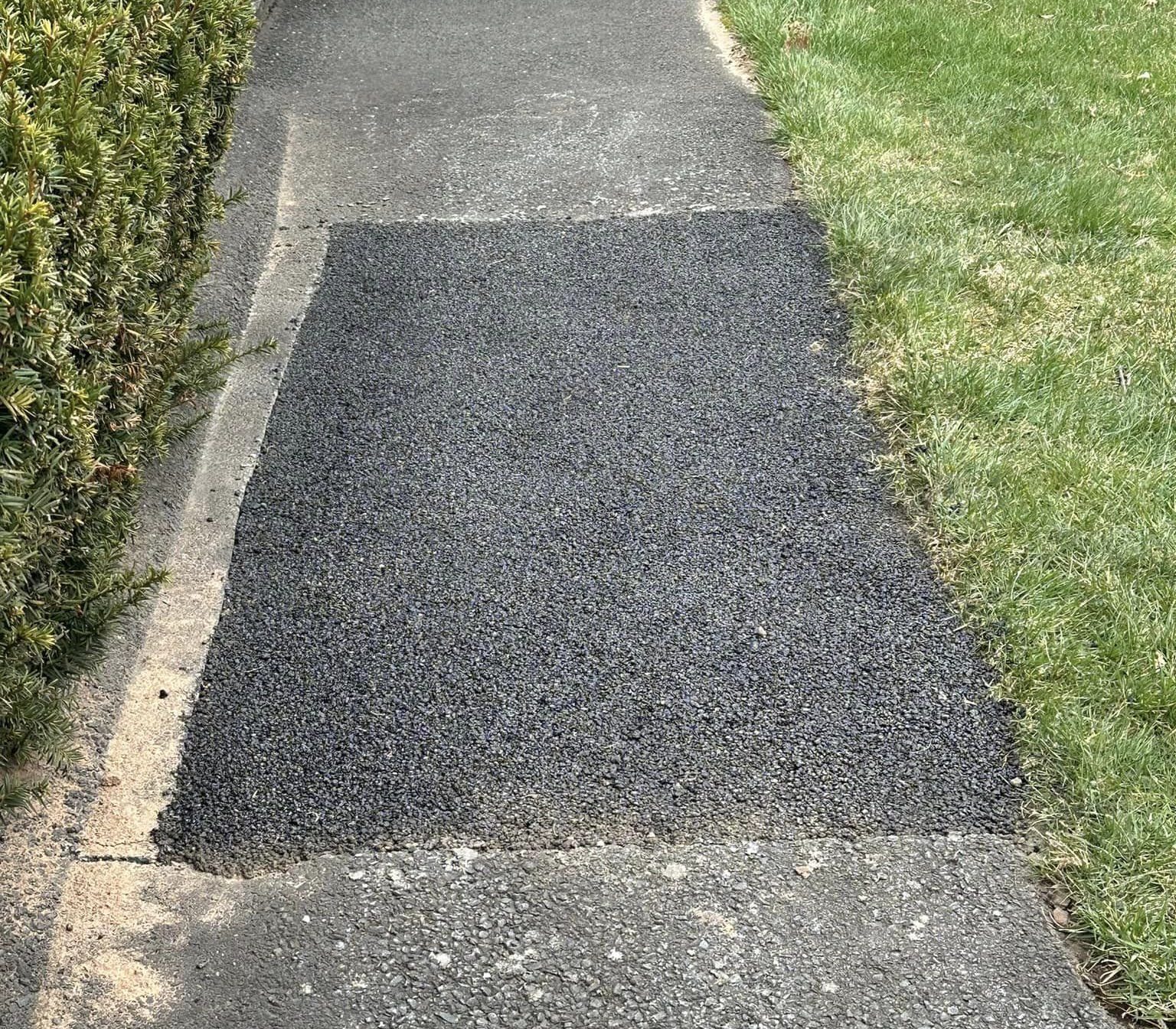 A skilled worker from Fasano's Sealcoating is performing patchwork on a damaged asphalt driveway in Meriden, CT. Using specialized tools, the technician fills and smooths out the potholes and cracks, restoring the surface to a like-new condition. Fasano's Sealcoating offers comprehensive patchwork services across all of Connecticut, ensuring durable and reliable repairs for various asphalt surfaces.