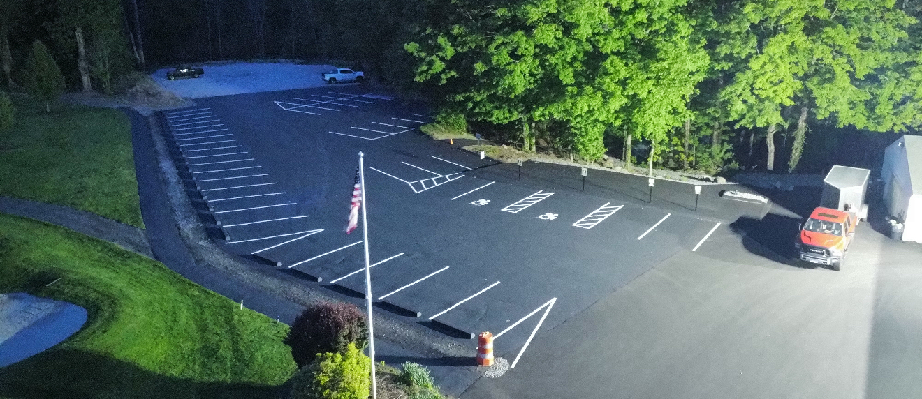 Freshly paved parking lot with professional line striping by Fasano's Sealcoating.